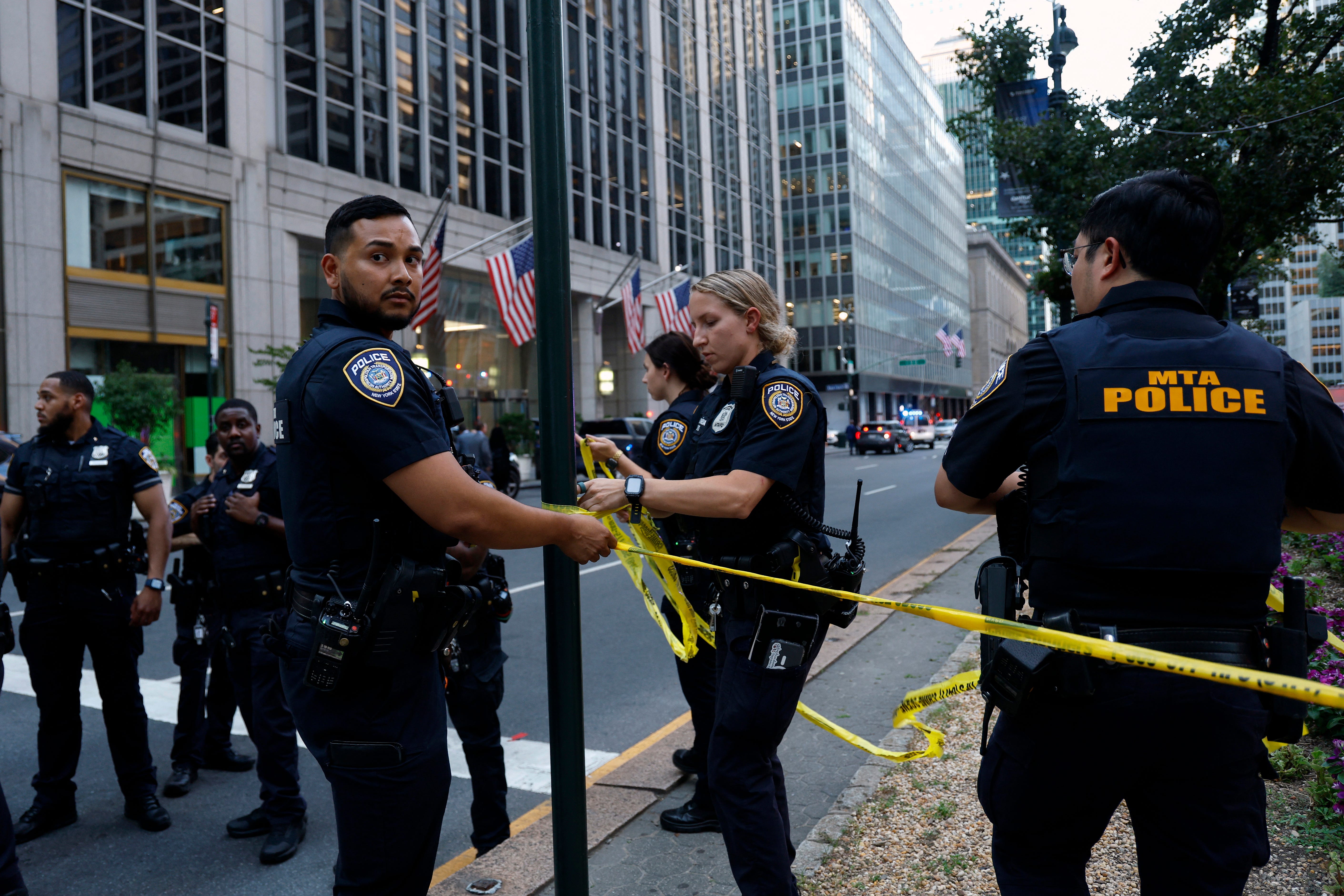 Police put up caution tape near 345 Park Avenue as the NYPD investigates reports of a shooting.