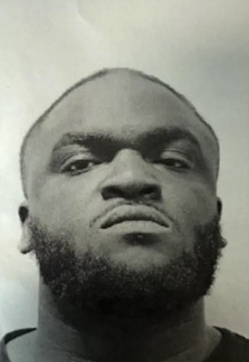 Black and white mugshot of a man.