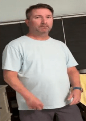 Man in light blue t-shirt.