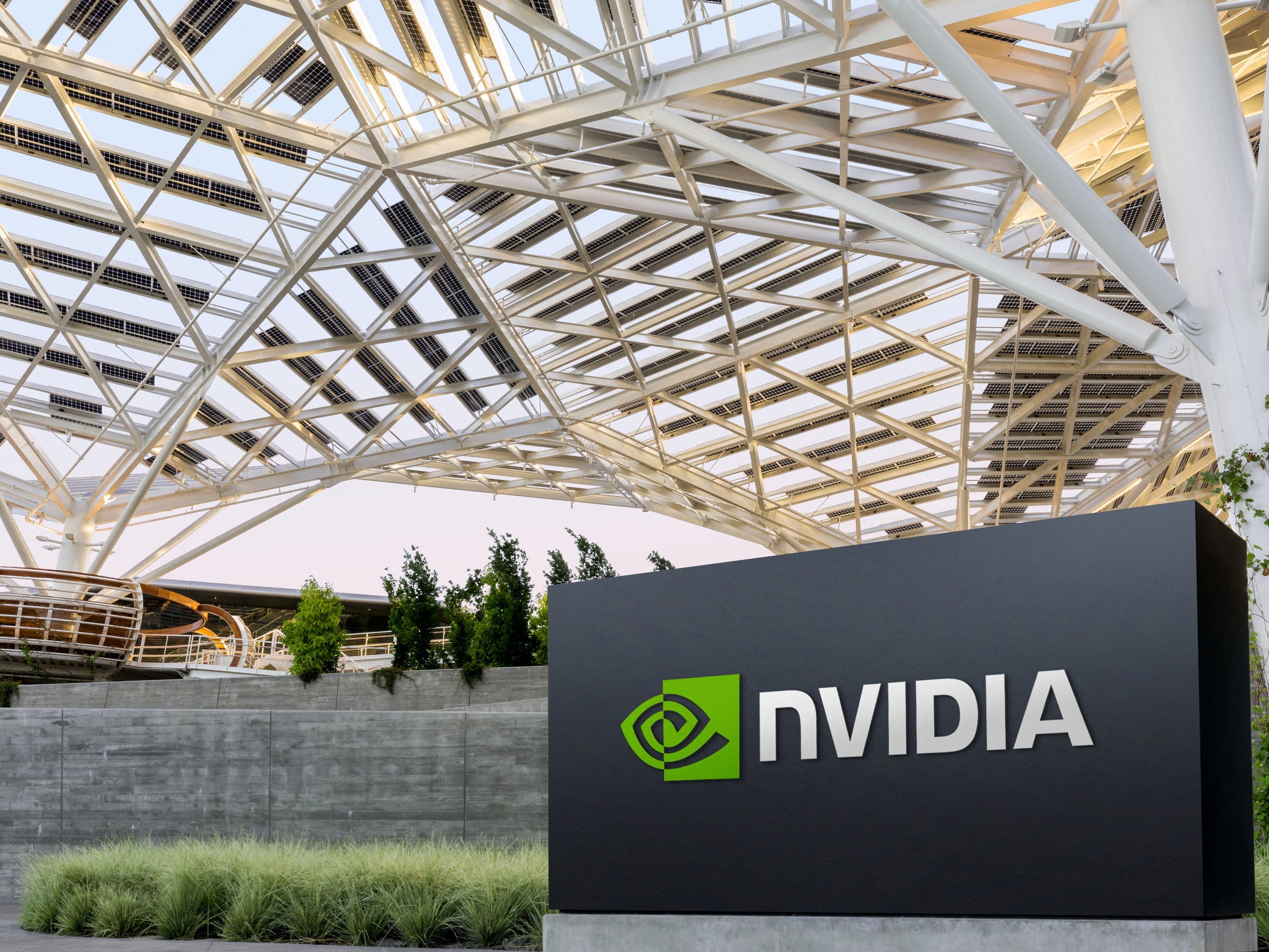 An Nvidia sign sits beneath a white metal canopy at Nvidia headquarters in Santa Clara, Califorina