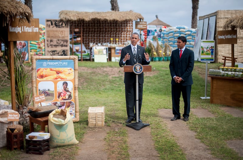 US President Barack Obama speaks June 28, 2013 before USAID administrator Raj Shah (R) during an event on food security in Dakar. Obama flies to South Africa later on June 27 to pay homage to his former President Nelson Mandela, who is fighting for his life in hospital. AFP PHOTO/JIM WATSON (Photo credit should read JIM WATSON/AFP via Getty Images)