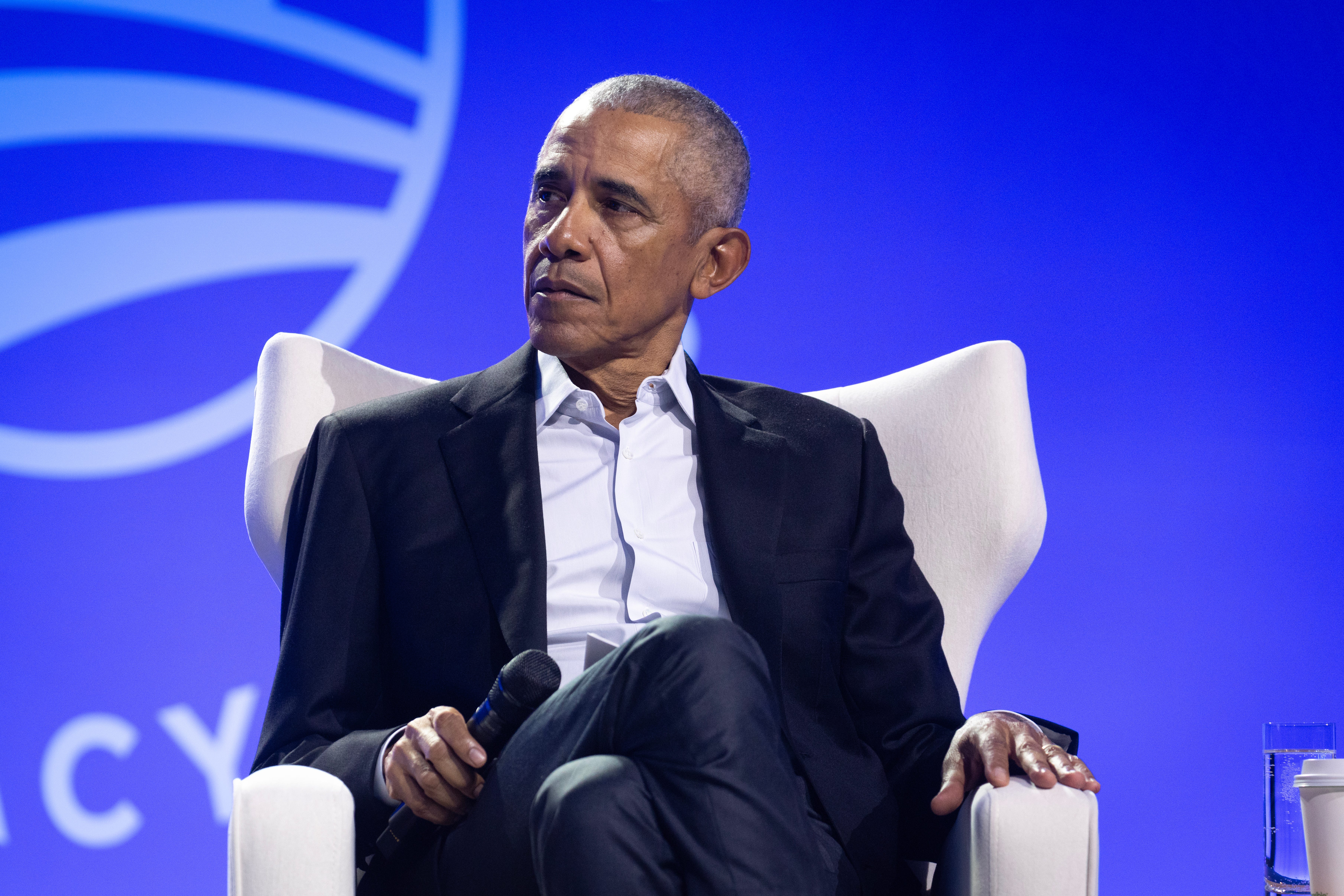 Former President Barack Obama moderating a discussion at a forum in Chicago, Illinois.