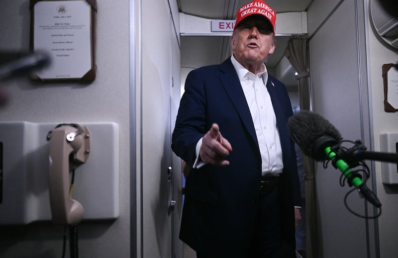 President Donald Trump speaks to journalists aboard Air Force One after departing Joint Base Andrews, Maryland on his way to Bedminster, New Jersey on July 4, 2025.