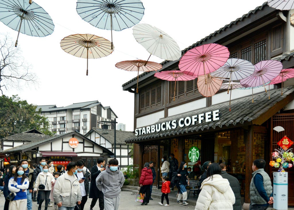 People walk by a Starbucks Coffee at Ciqikou ancient town on February 14, 2022 in Chongqing, China.