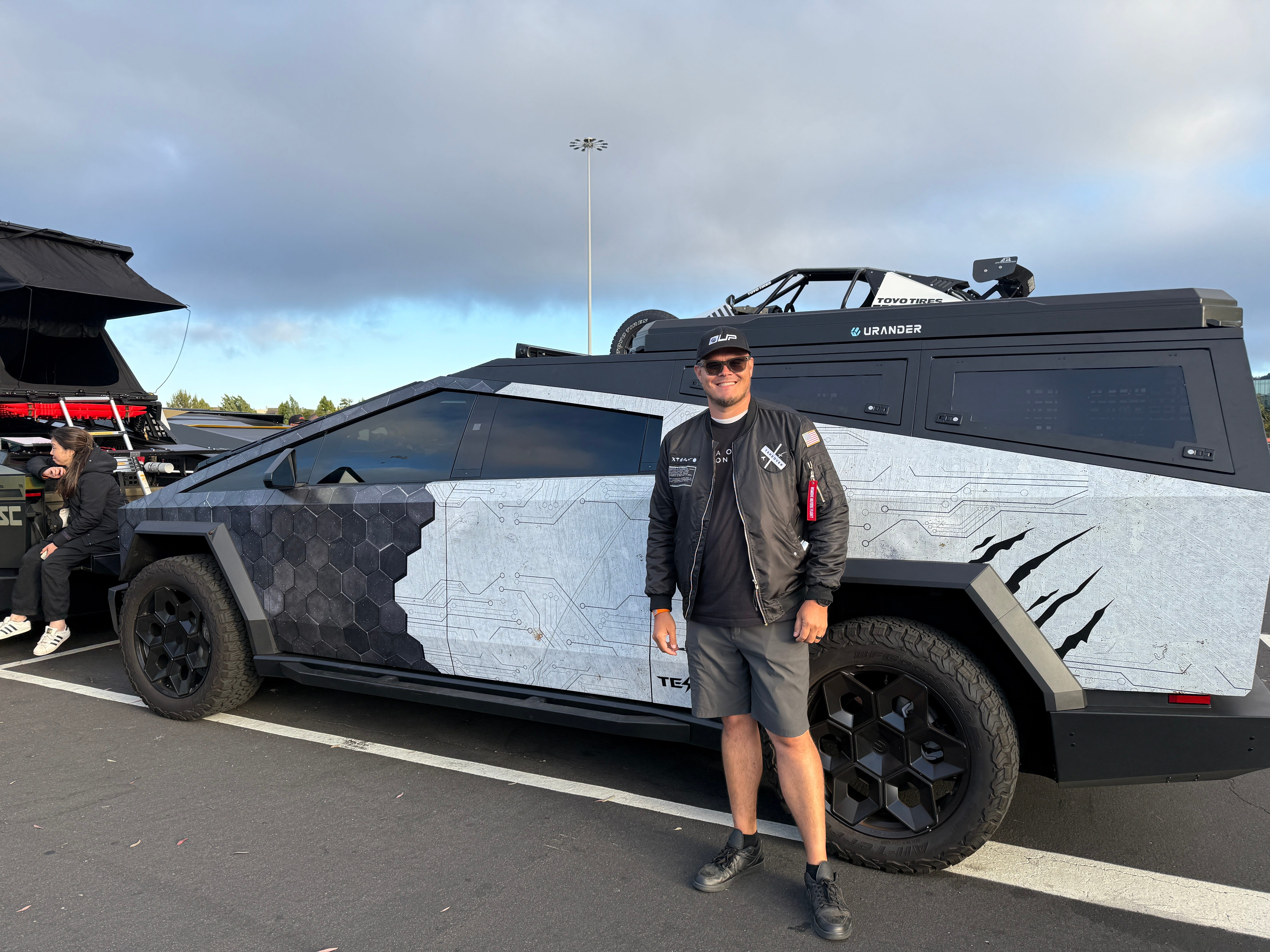 Man in front of black and white truck.