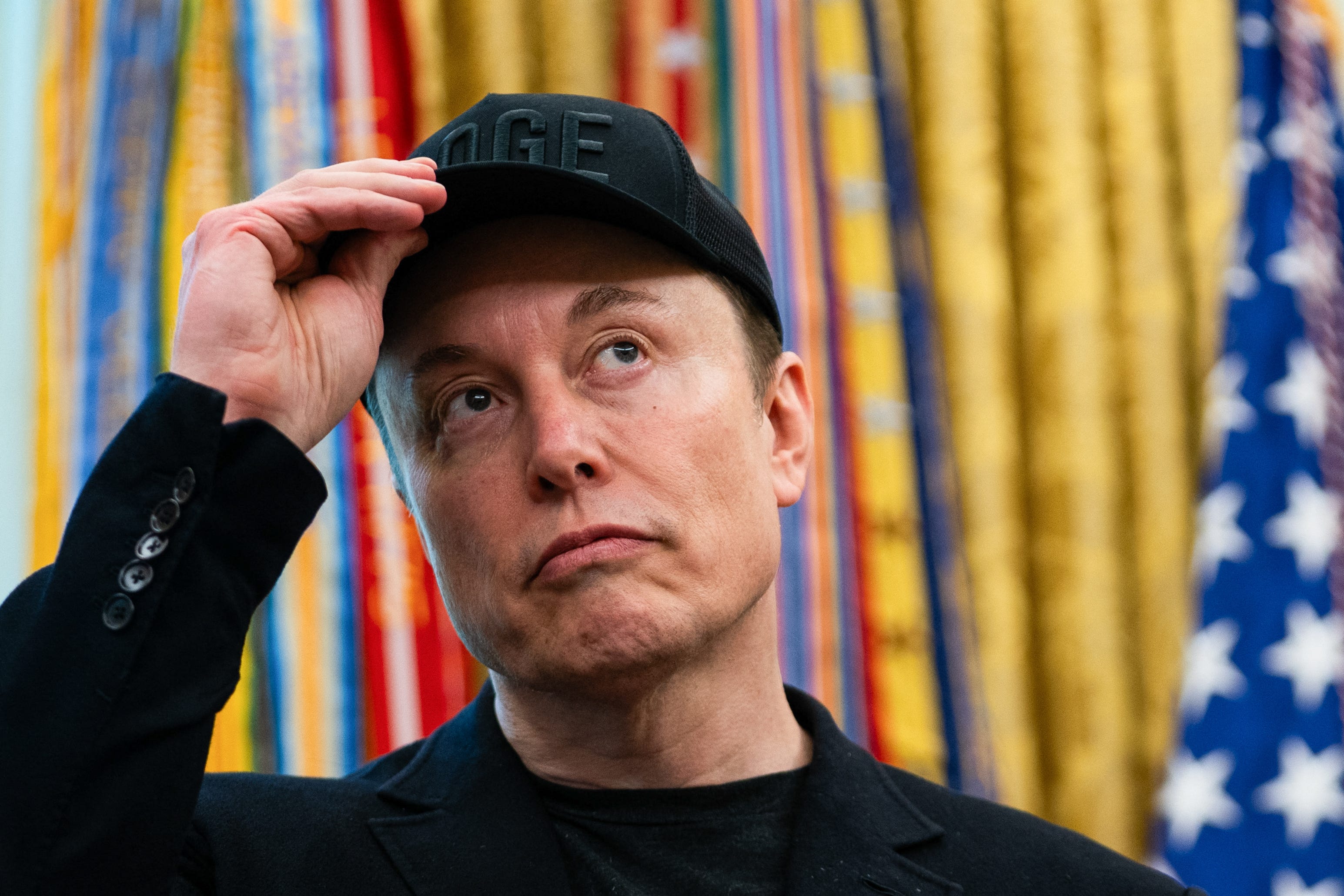 Elon Musk wearing DOGE hat