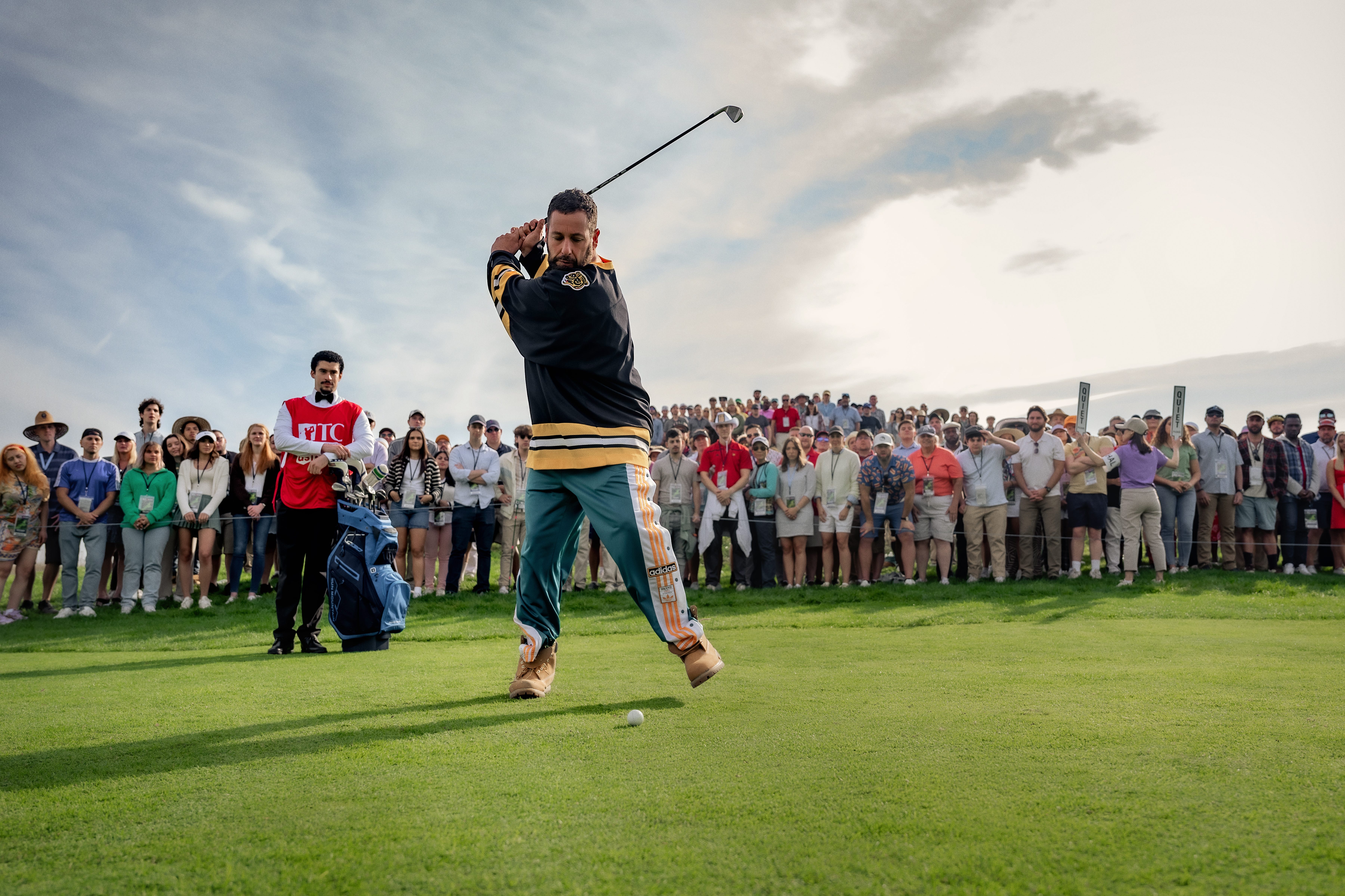 Adam Sandler hitting a golf ball
