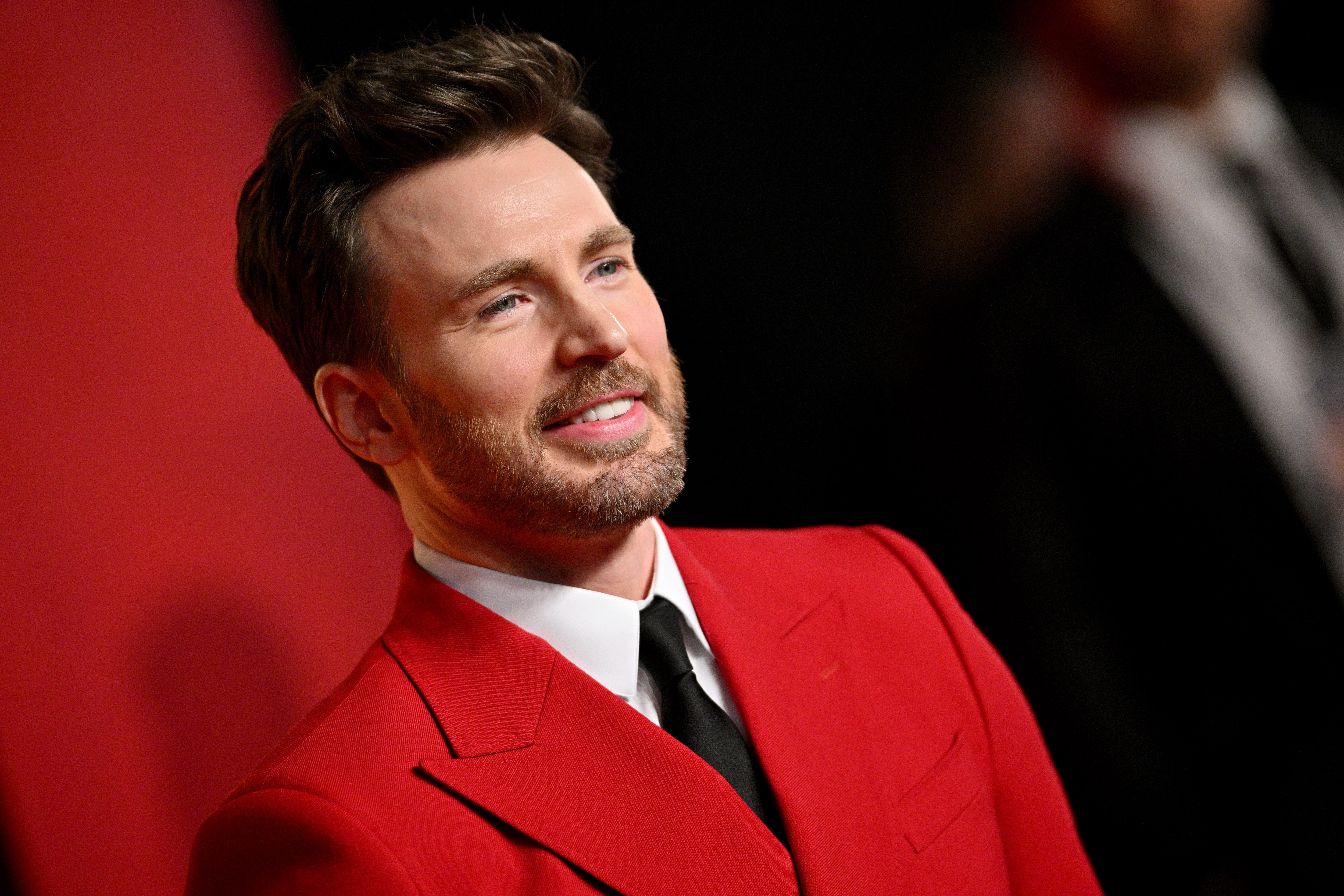 Chris Evans in a red jacket and black tie