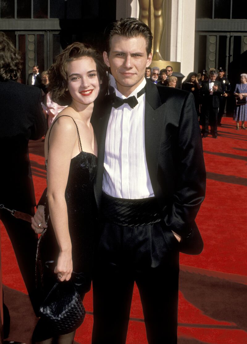 Winona Ryder and Christian Slater attend the 1989 Academy Awards.