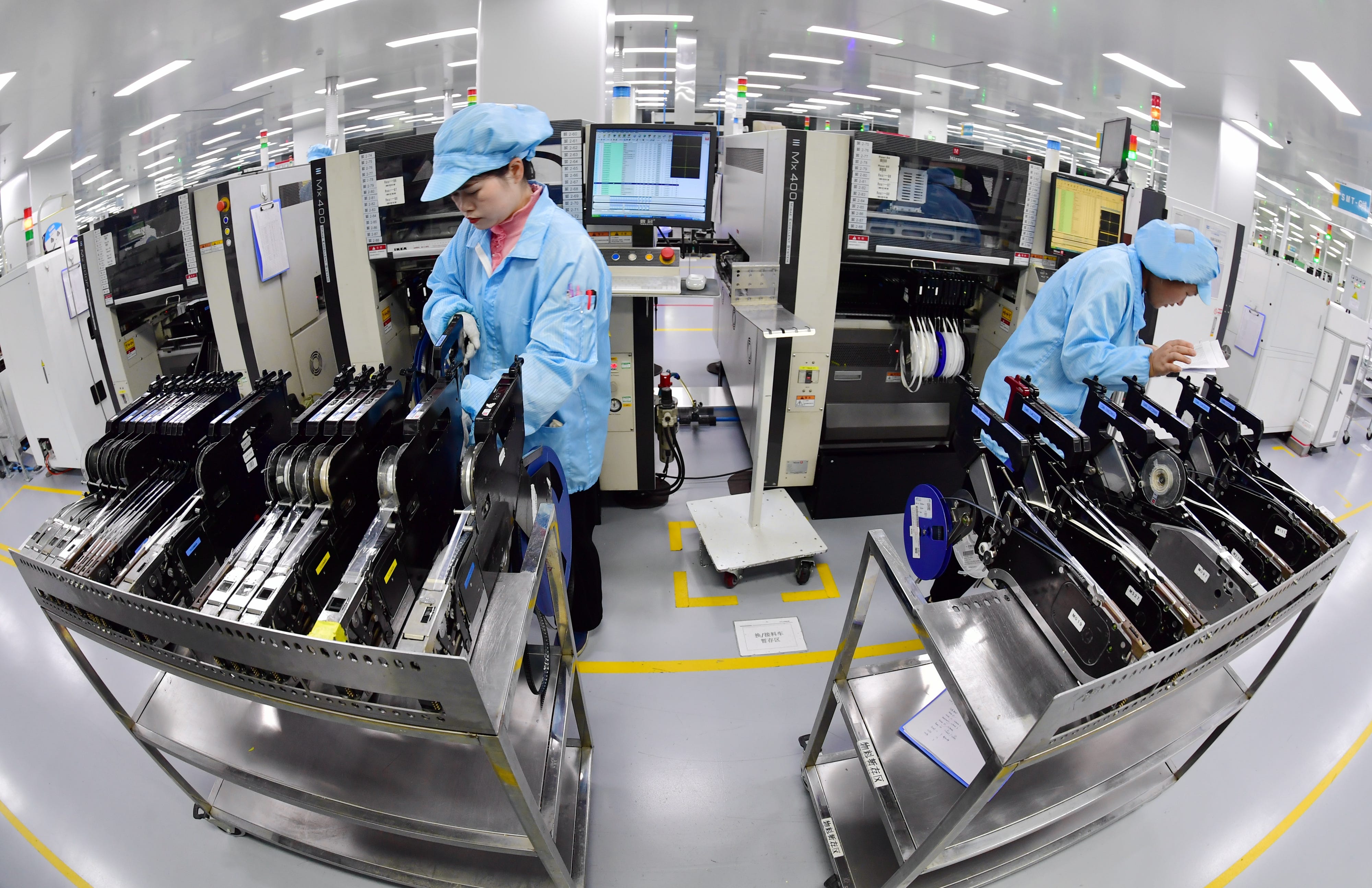 Workers applying digital technology to produce core components of an elevator in Haian, Jiangsu Province, China, on January 23, 2024.