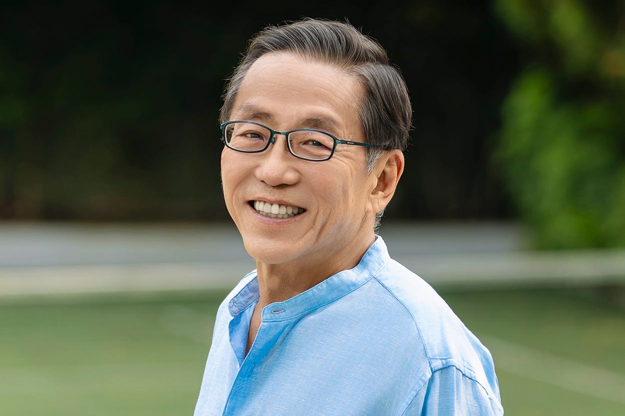 Kwon Ping Ho, founder and executive chair of Banyan Group, standing in a tennis court.