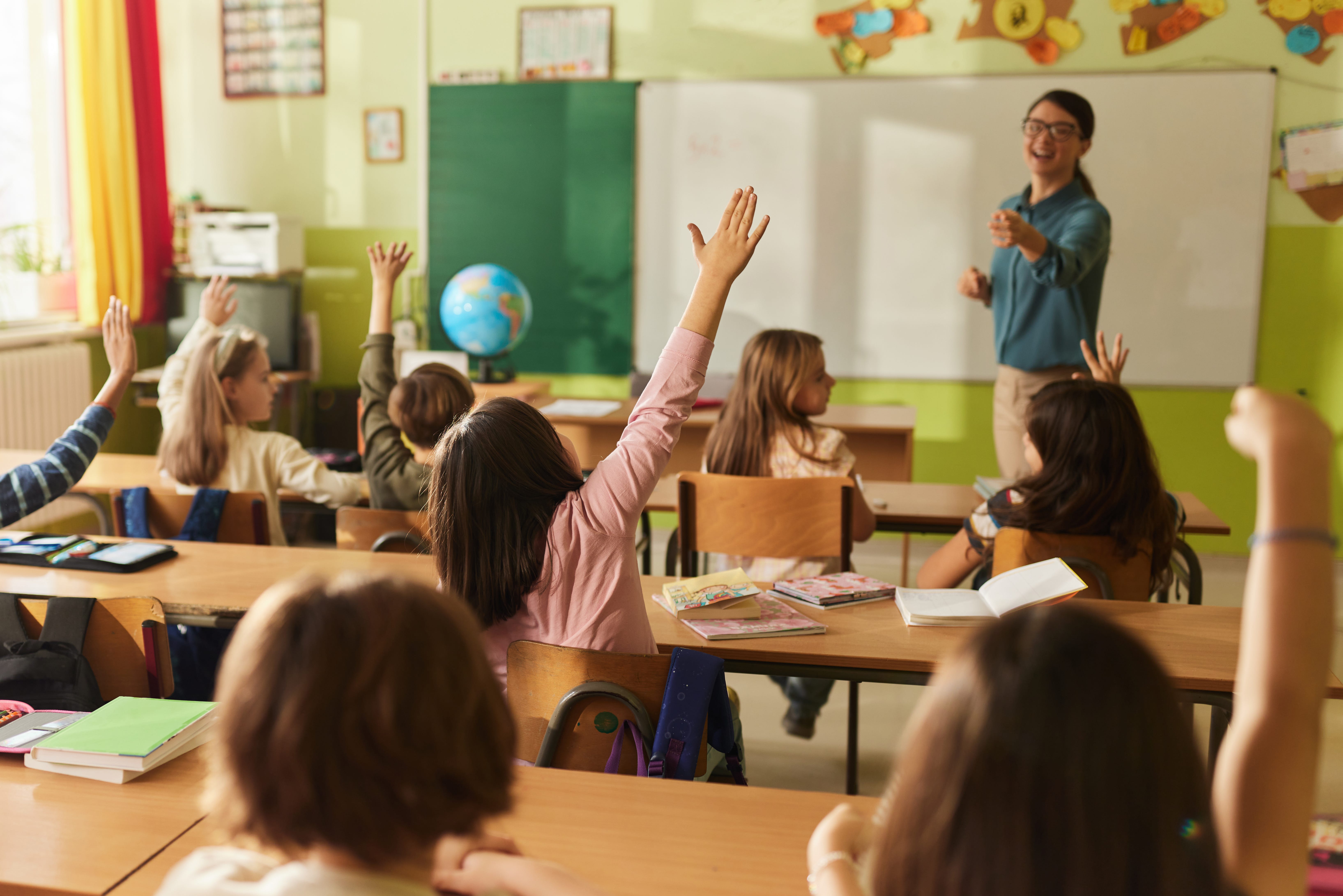 a teacher pointing at a student
