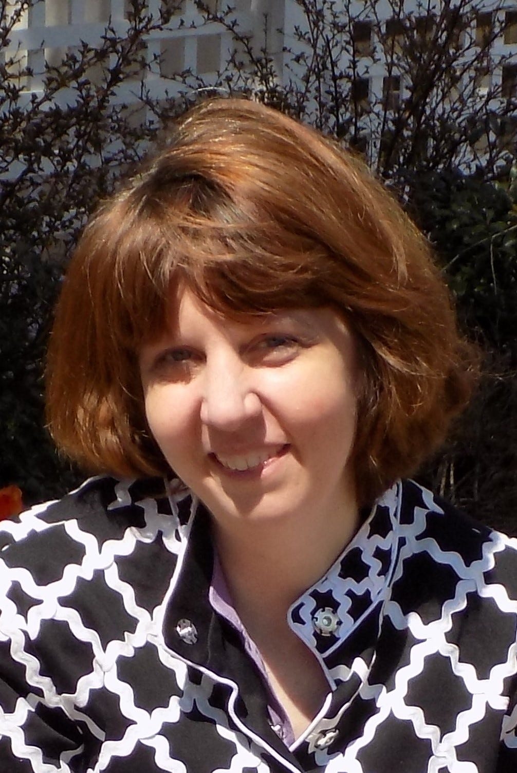 Picture of woman wearing a black and white shirt with short hair