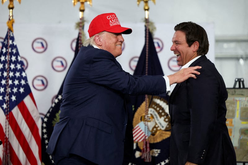 U.S. President Donald Trump shares a moment with Florida Governor Ron DeSantis after touring a temporary migrant detention center informally known as "Alligator Alcatraz" in Ochopee, Florida, U.S., July 1, 2025. REUTERS/Evelyn Hockstein     TPX IMAGES OF THE DAY