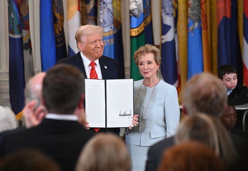 WASHINGTON, DC - MARCH 20: U.S. President Donald Trump holding up a signed executive order poses with U.S. Education Secretary Linda McMahon at the White House on March 20, 2025 in Washington, DC. Trump on March 20 signed an executive order to formally begin the process of dismantling the Education Department, saying that his administration is returning education back to the states. (Photo by Chen Mengtong/China News Service/VCG via Getty Images)