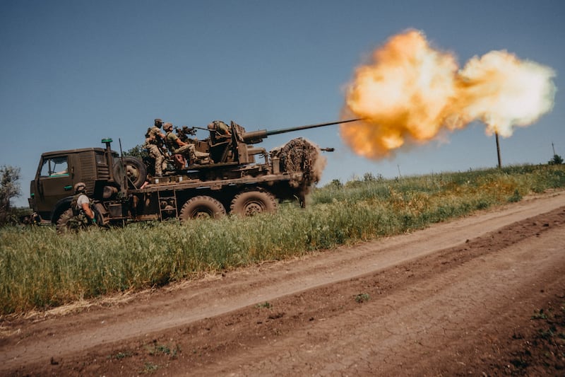 BAKHMUT, UKRAINE - JUNE 19: Ukrainian soldiers from the 60th Battalion of Territorial Defense, are shooting rounds into Russian positions with an S60 anti-aircraft canon placed on a truck, outside Bakhmut, Ukraine on June 19, 2023. (Photo by Wojciech Grzedzinski/Anadolu Agency via Getty Images)