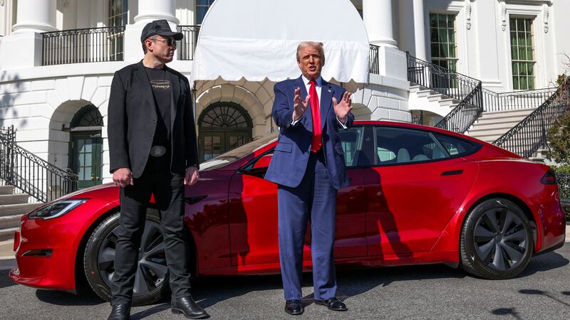Trump and Musk during a photo op with a Tesla at the White House in March.
