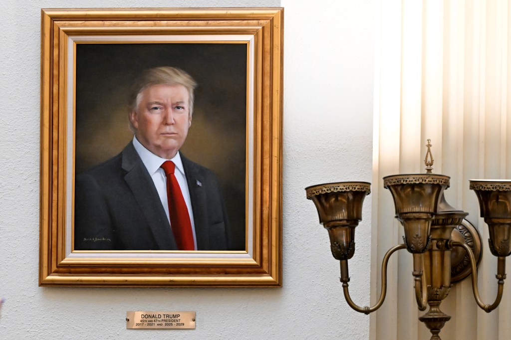 Portrait of Donald Trump in a gold frame.