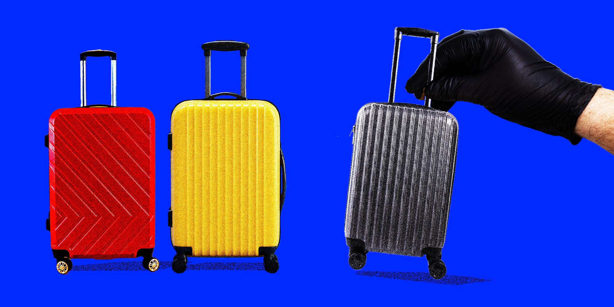 Two suitcases standing with one grey suitcase being pulled away with a hand with black gloves on