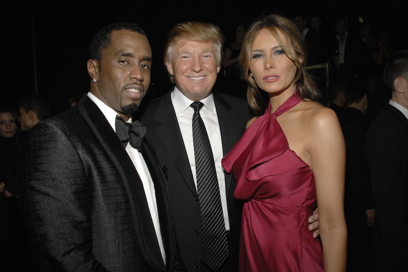 (L-R) Sean Combs, Donald Trump and Melania Trump attend a benefit at the United Nations on February 6, 2008 in New York City.