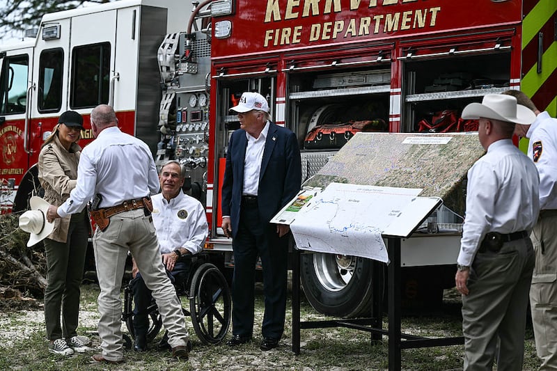US President Donald Trump, Texas Governor Greg Abbott, and First Lady Melania Trump meet with local officials and first responders near the Guadalupe River following devastating flooding that ocurred in the area over the July 4 weekend, in Kerrville, Texas, on July 11, 2025. Picture: Brendan Smialowski/AFP via Getty Images