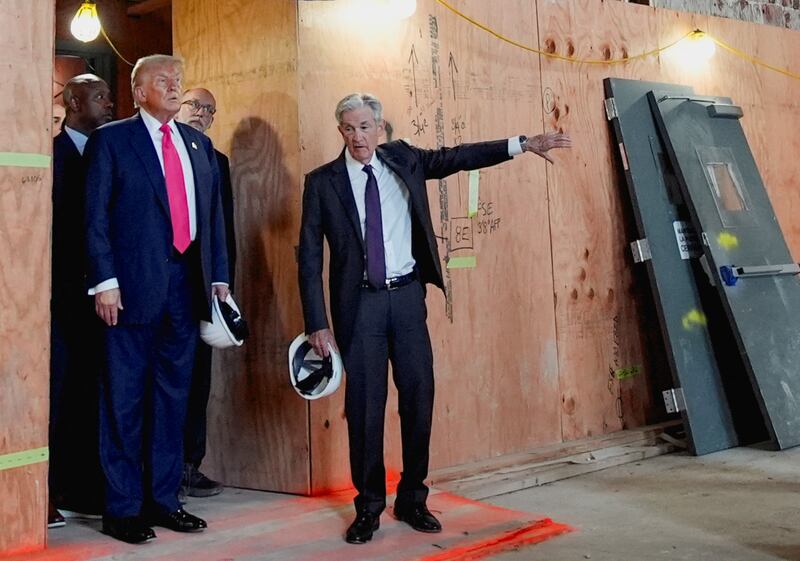 Federal Reserve Chair Jerome Powell gestures as U.S. President Donald Trump looks on during a tour of the Federal Reserve Board building, which is currently undergoing renovations, in Washington, D.C., U.S., July 24, 2025. REUTERS/Kent Nishimura