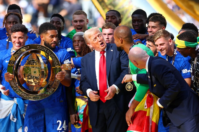 President Trump's pal FIFA President Gianni Infantino tries and fails to get him to leave the trophy stand so the team can celebrate.