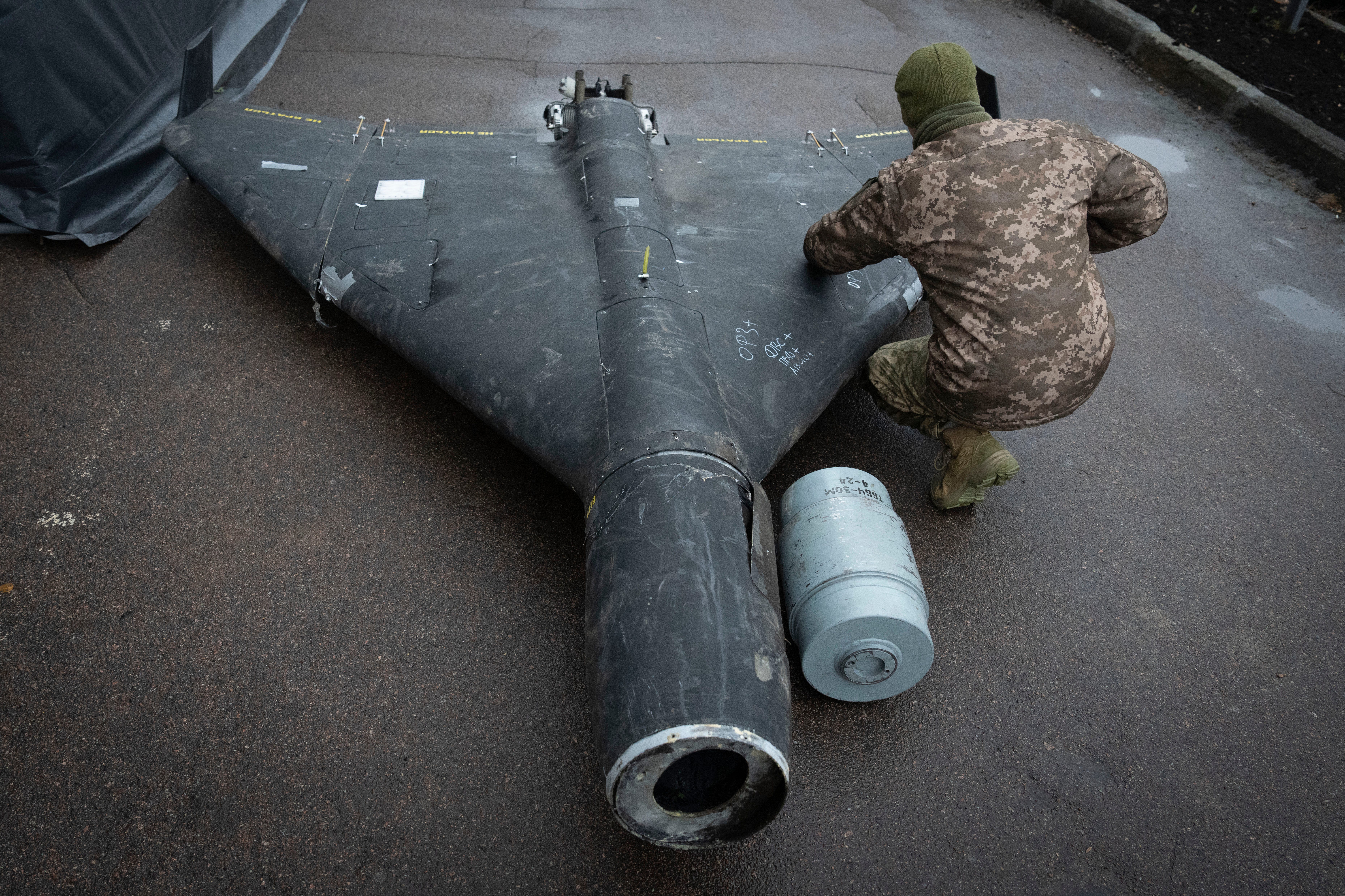 A Ukrainian officer examines a downed Shahed drone with a thermobaric charge launched by Russia in a research laboratory in an undisclosed location in Ukraine on Nov. 14, 2024.