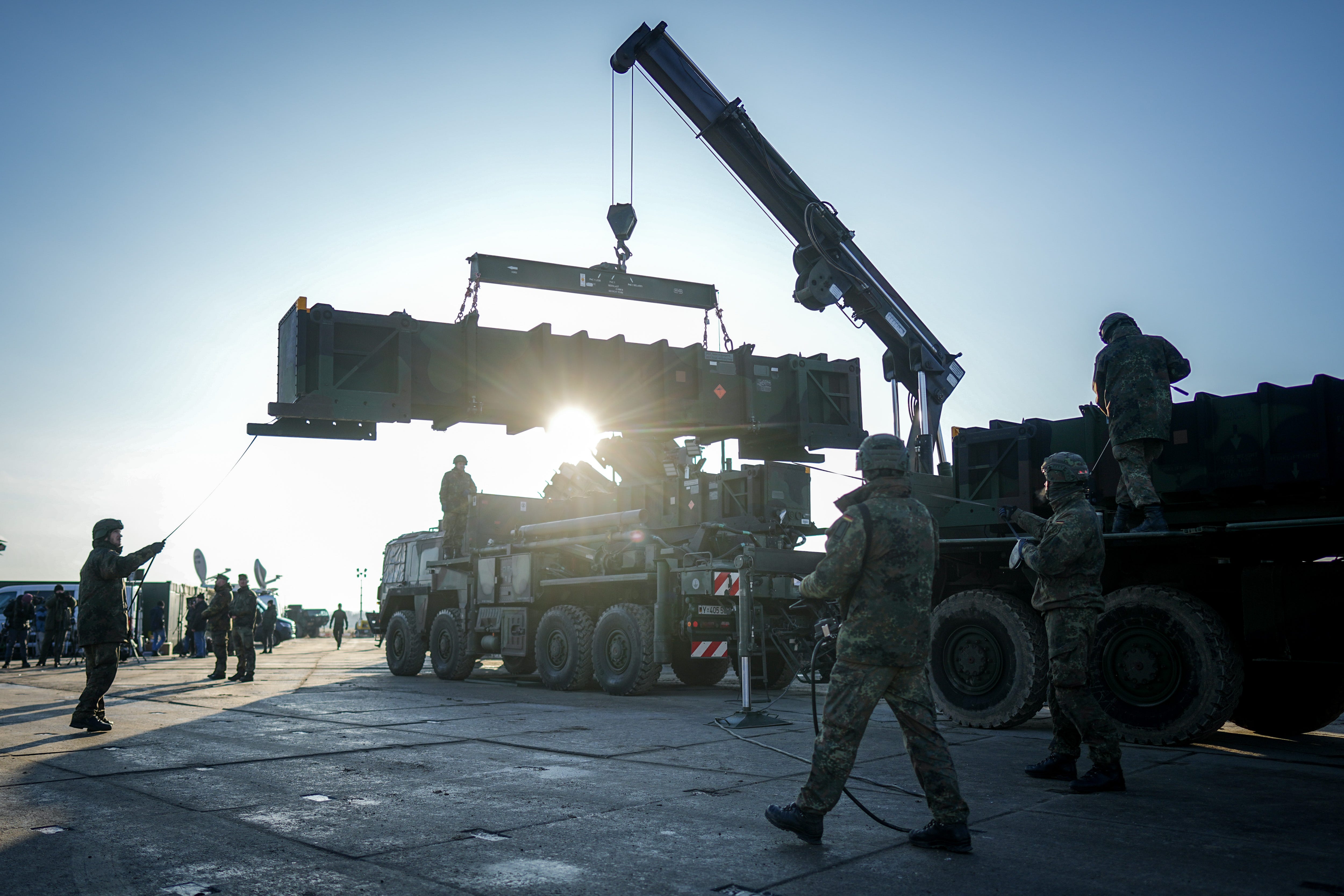 German soldiers load missiles for the Patriot air defense system.