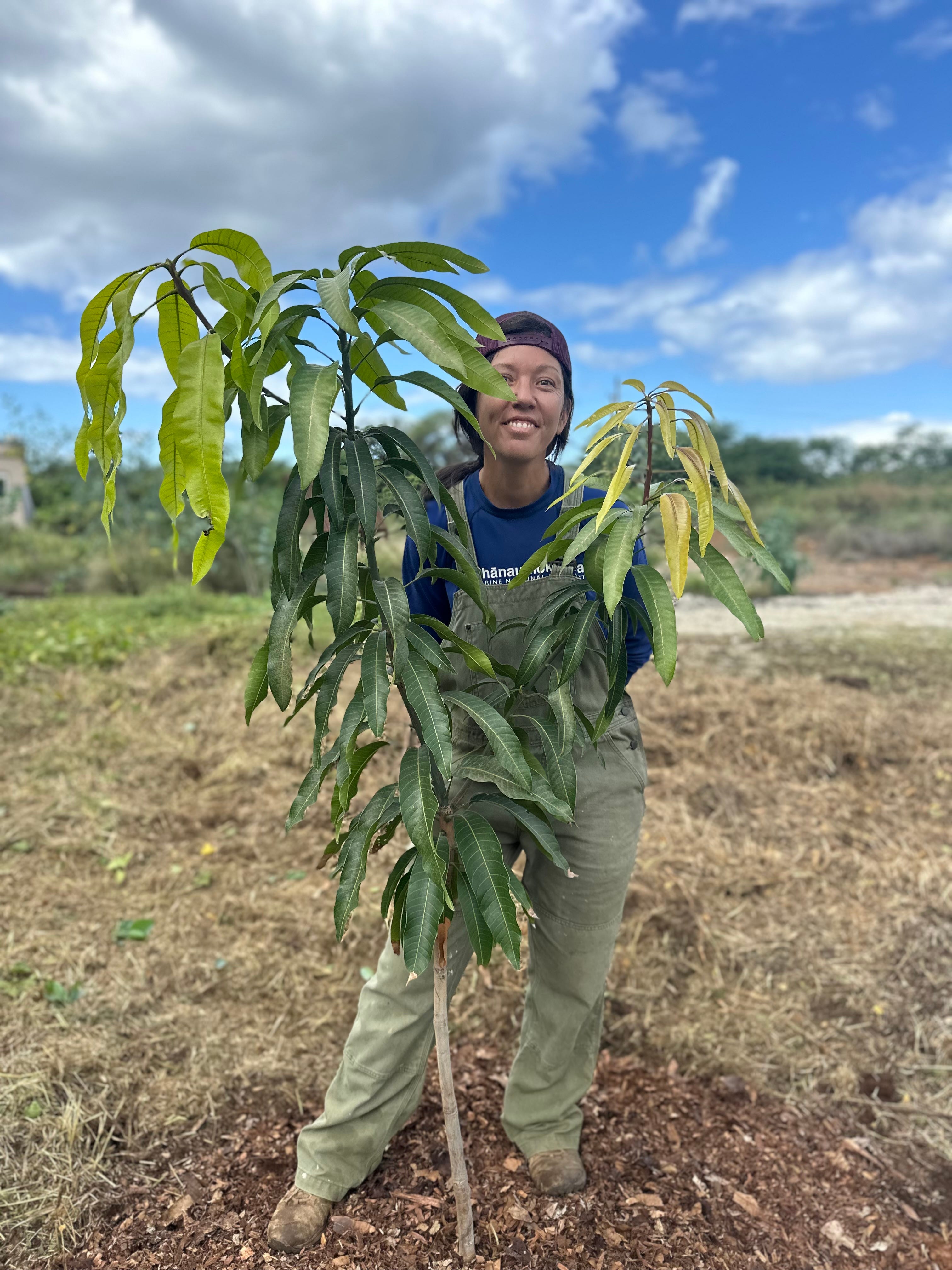 Christy Werner standing next to a tree