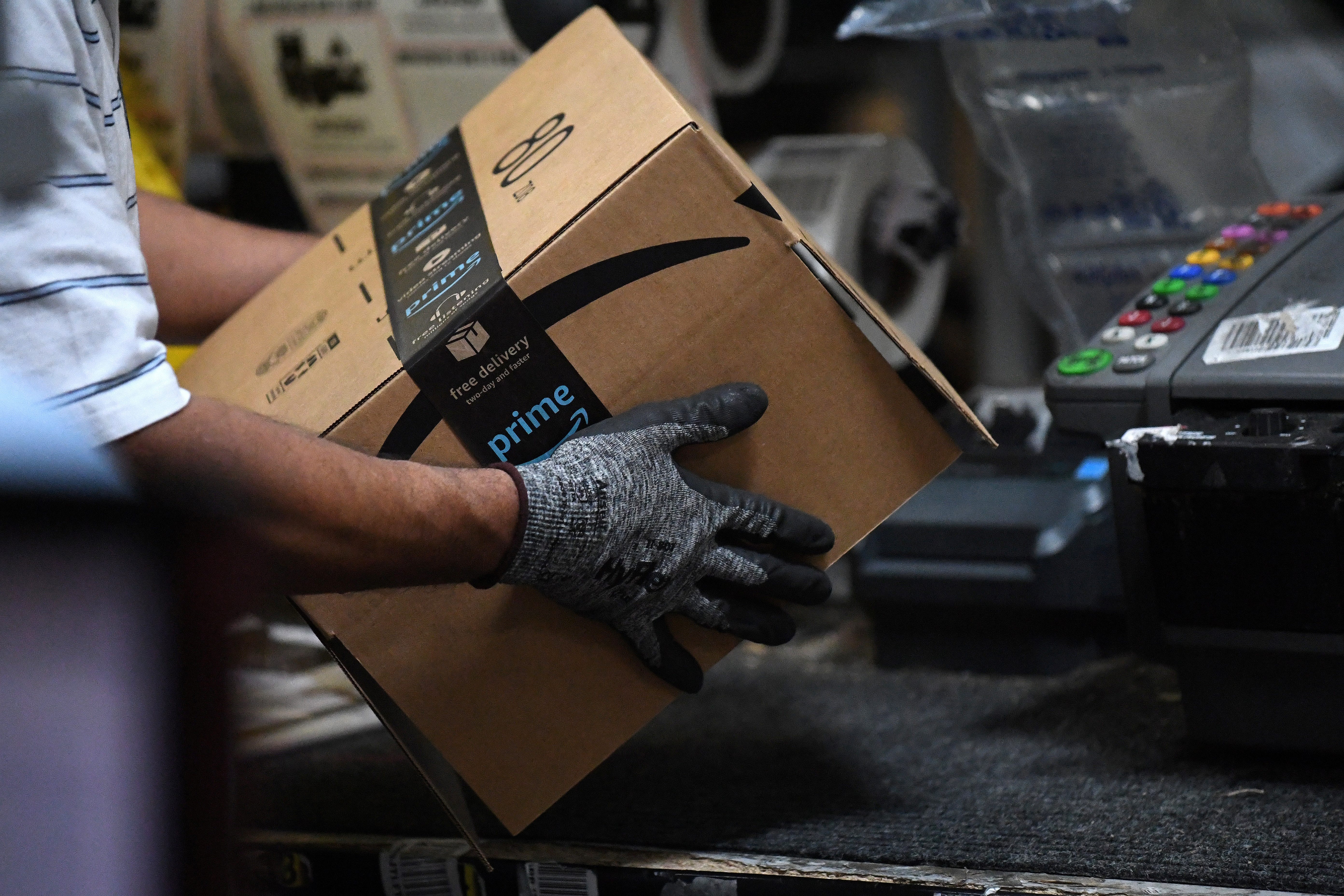 FILE PHOTO: A worker assembles a box for delivery at the Amazon fulfillment center in Baltimore, Maryland, U.S., April 30, 2019. REUTERS/Clodagh Kilcoyne/File Photo