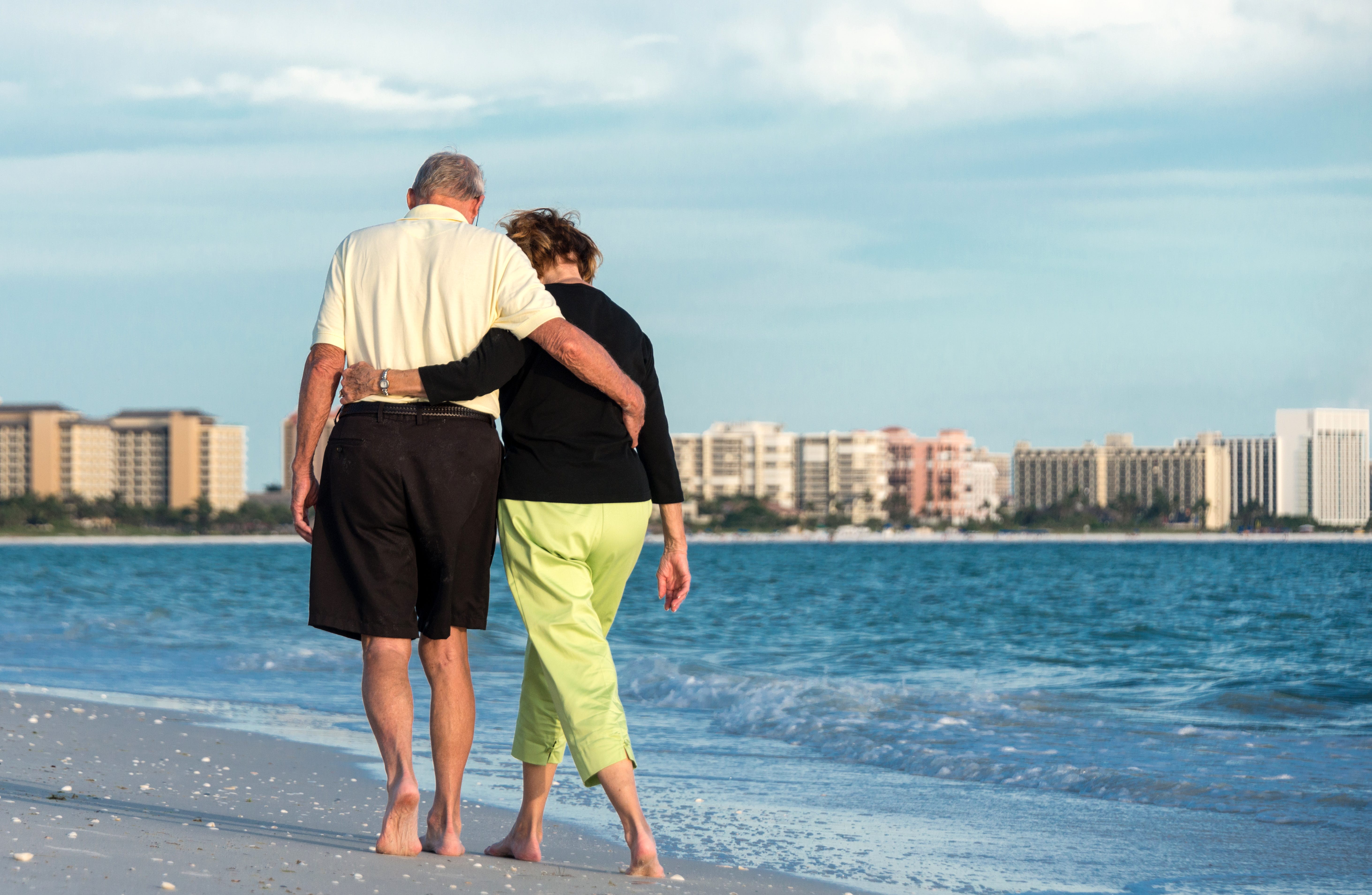 Elderly couple walking about the beach