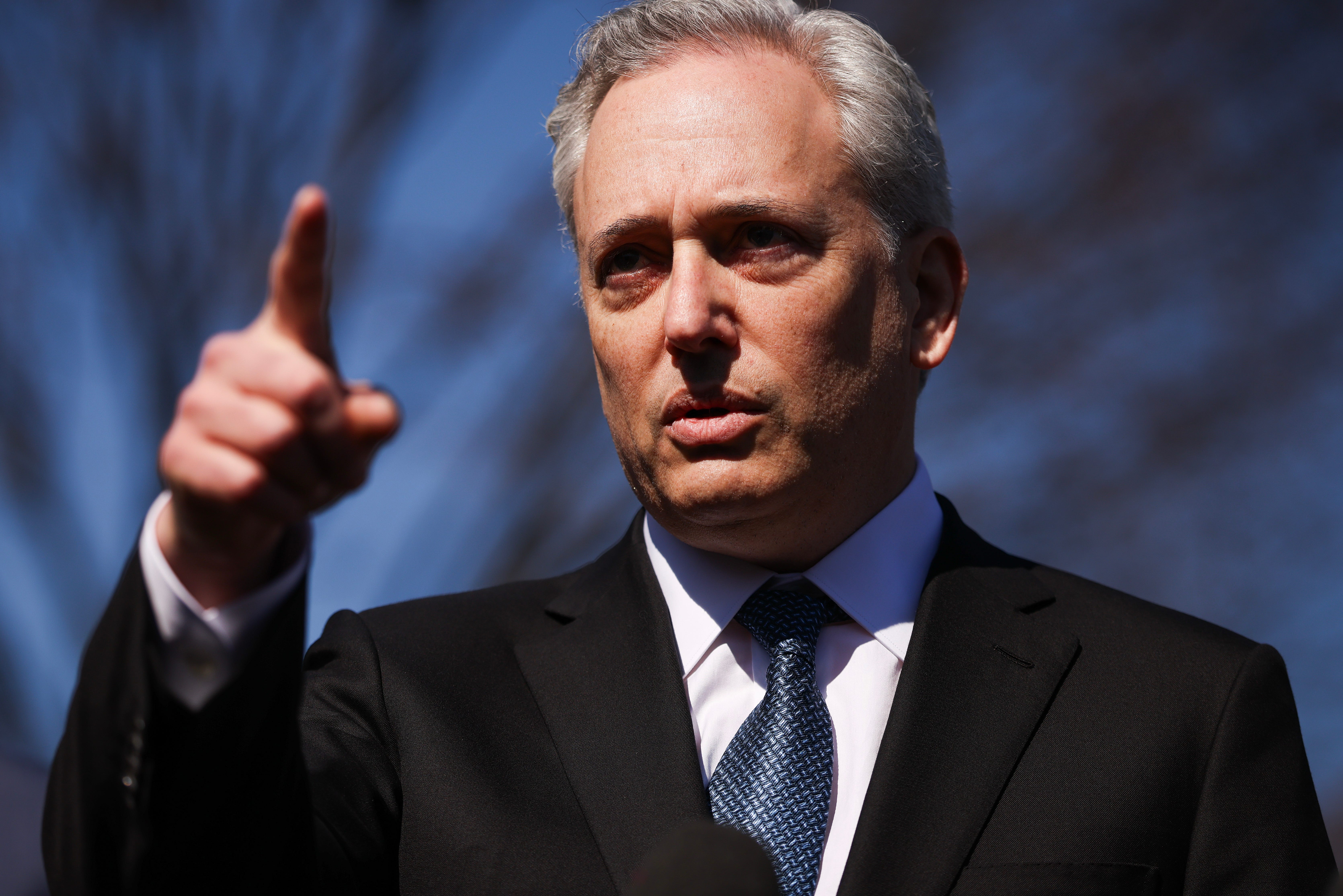 David Sacks, President Donald Trump's AI and cryptocurrency czar, wearing a suit and pointing.