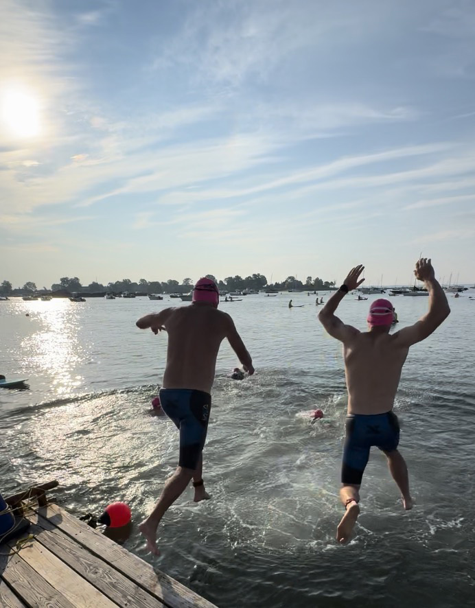 Two swimmers diving into the water.