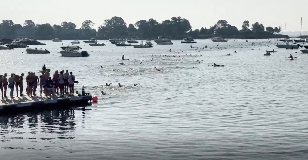 Group of swimmers competing in a number of races in the Long Island Sound for Swim Across America.