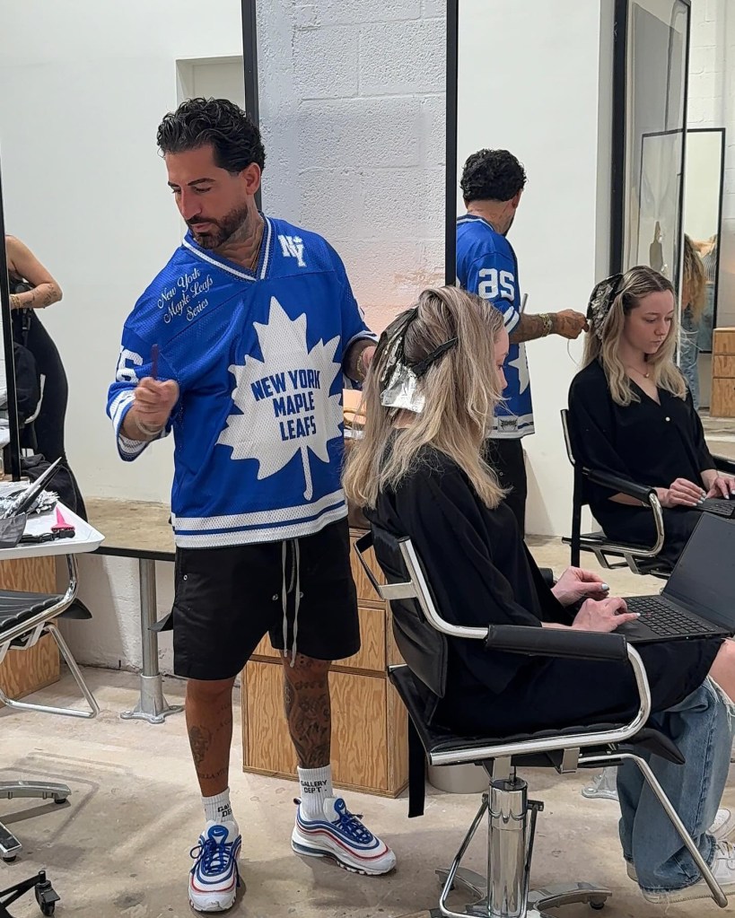 Hair colorist applying hair color to clients in a salon.