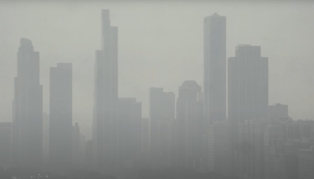 City skyline obscured by haze.