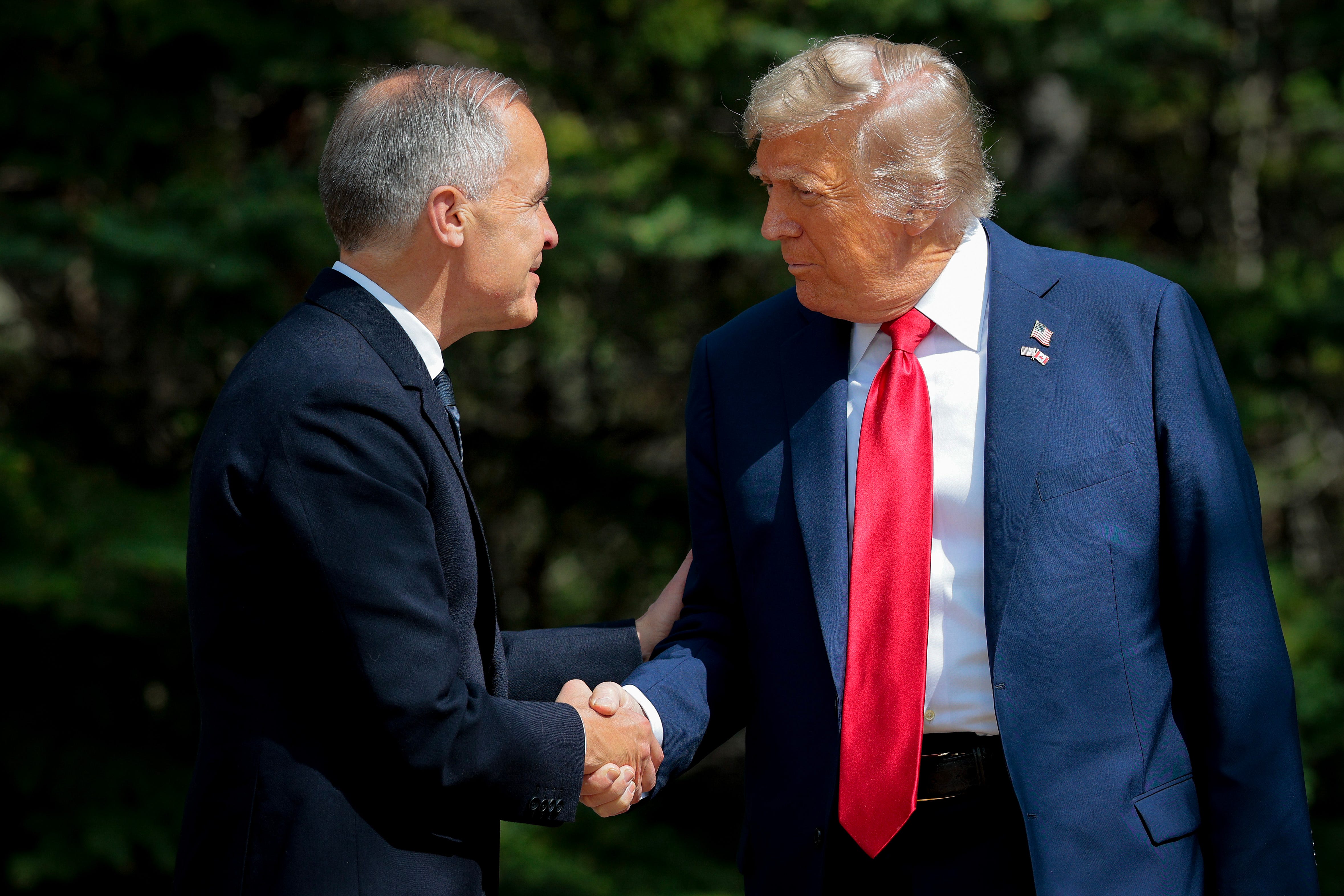 Two men shake hands