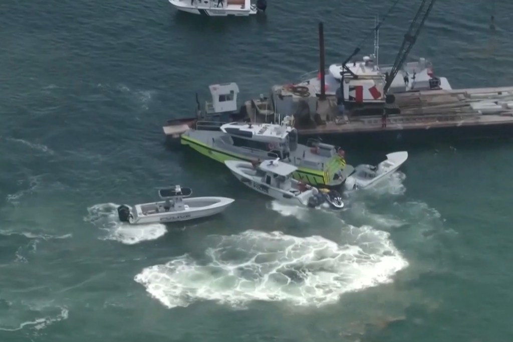 Aerial view of boats in the water near a barge.