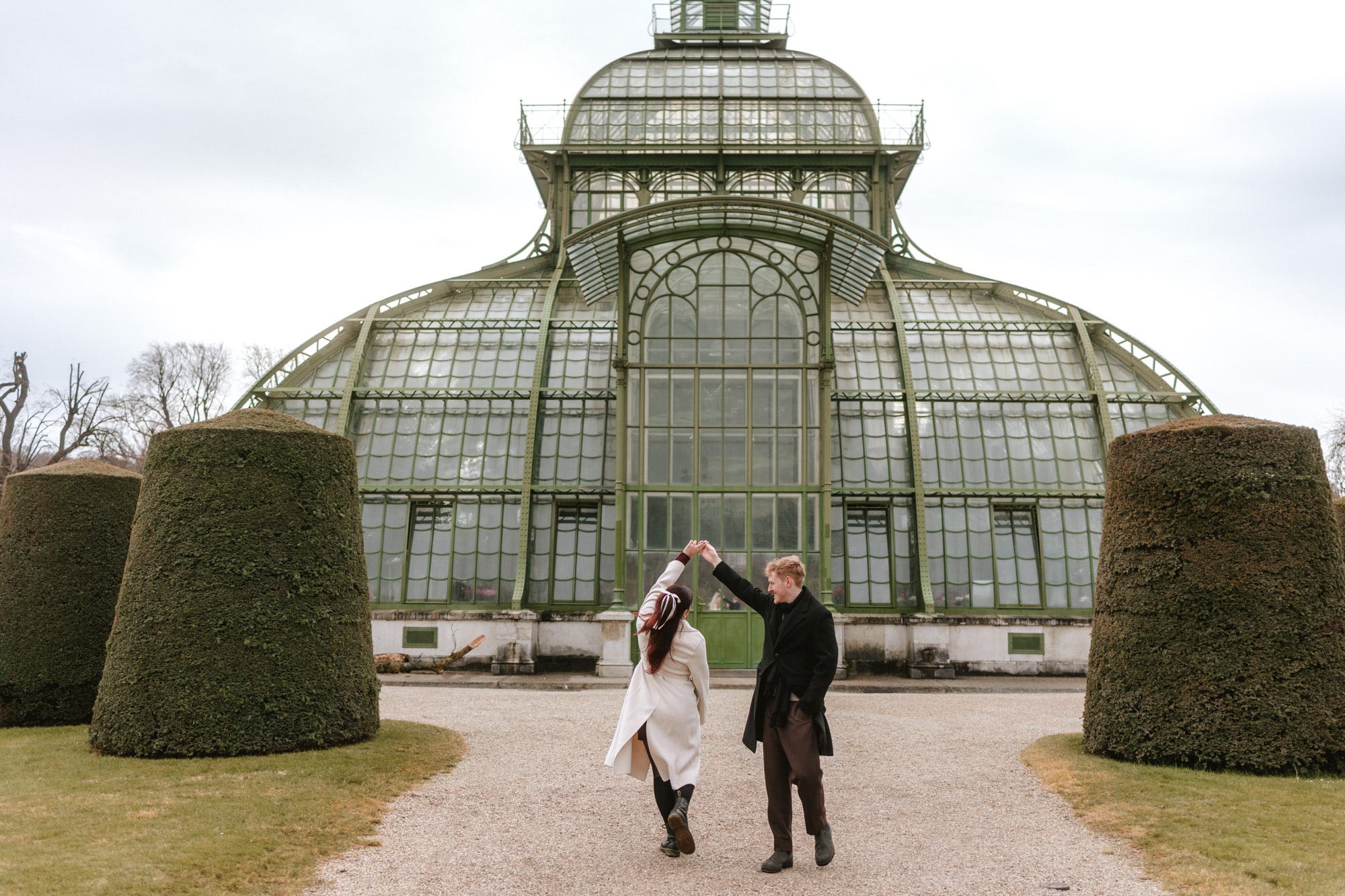 engagement photo of man twirling woman in outdoor setting