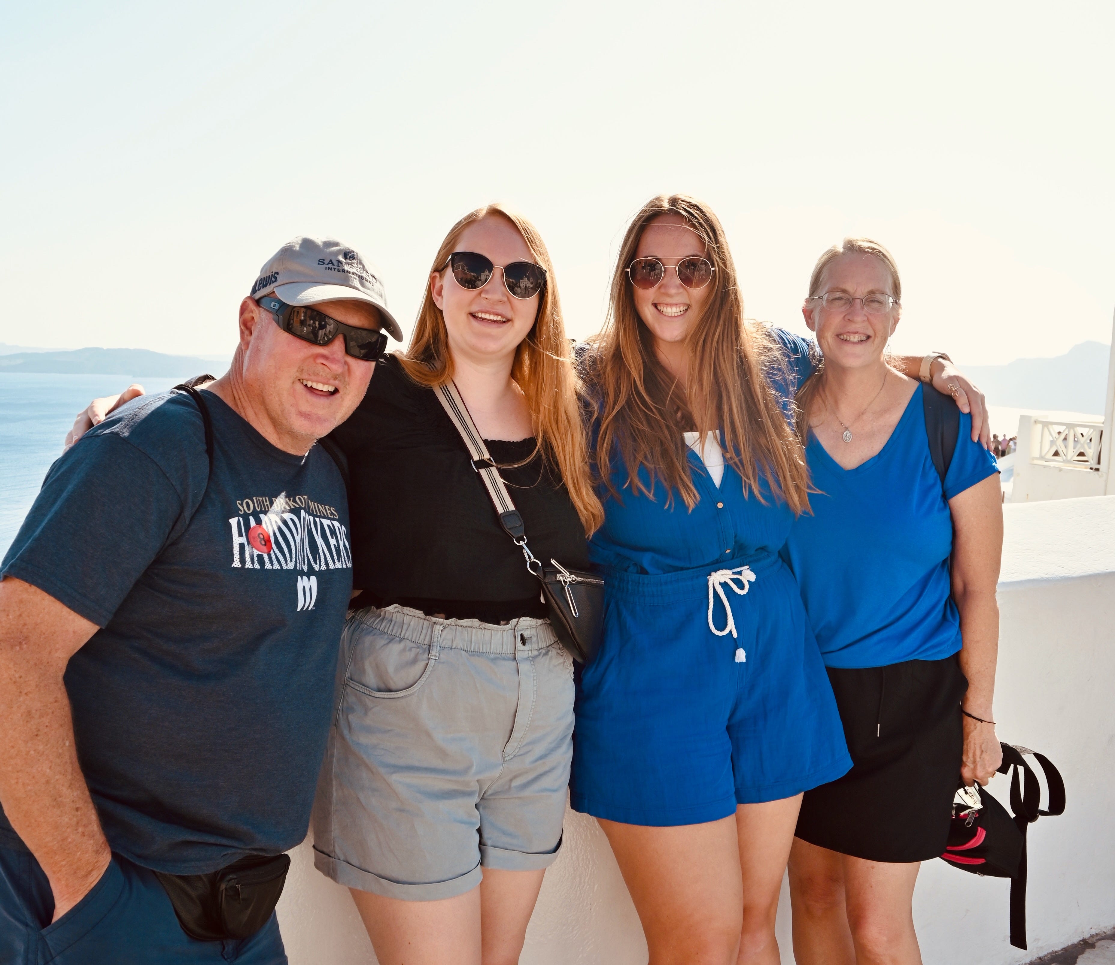 Allie Hubers and family members smiling in Santorini