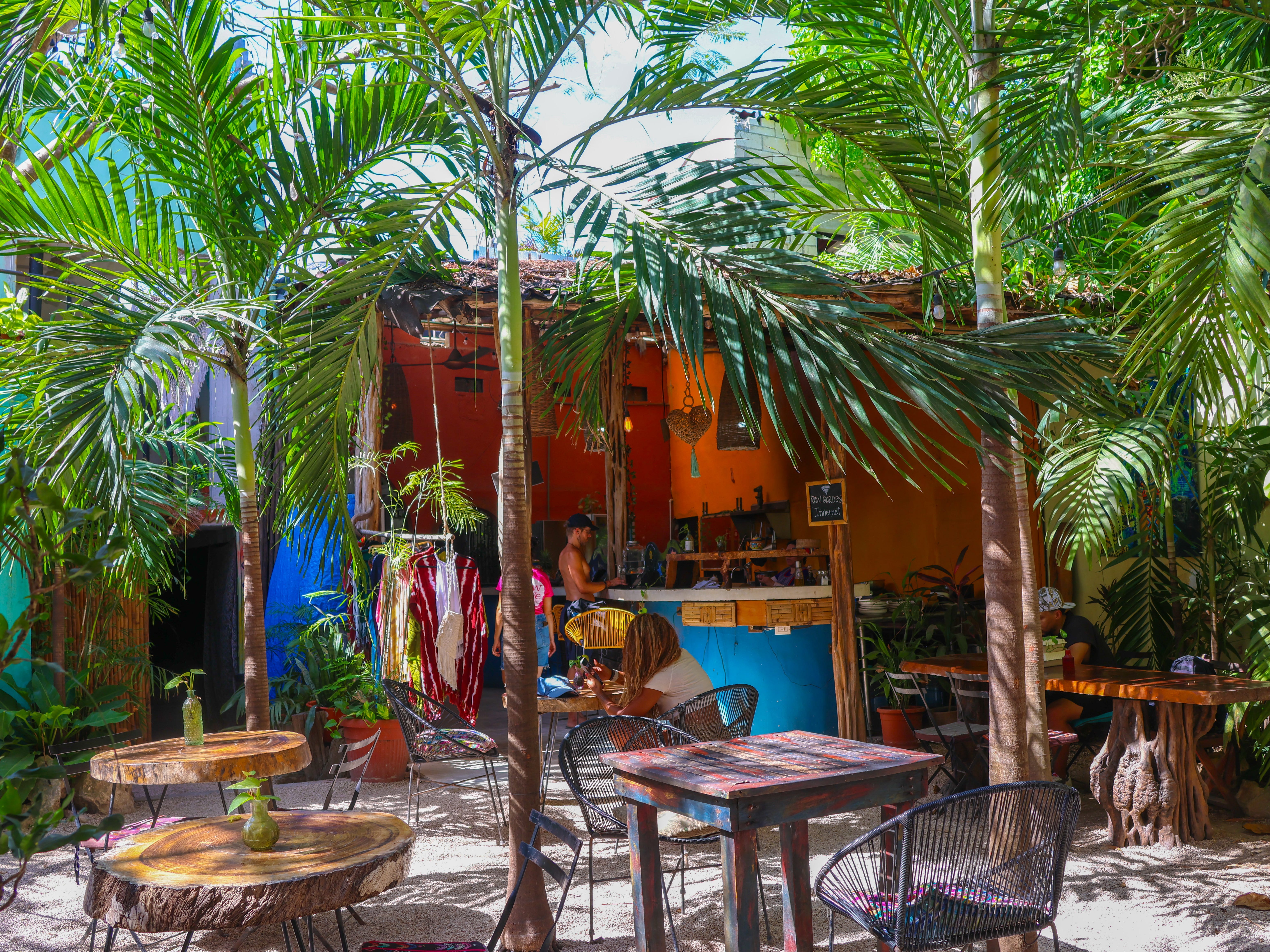 An outdoor café with plants and trees.