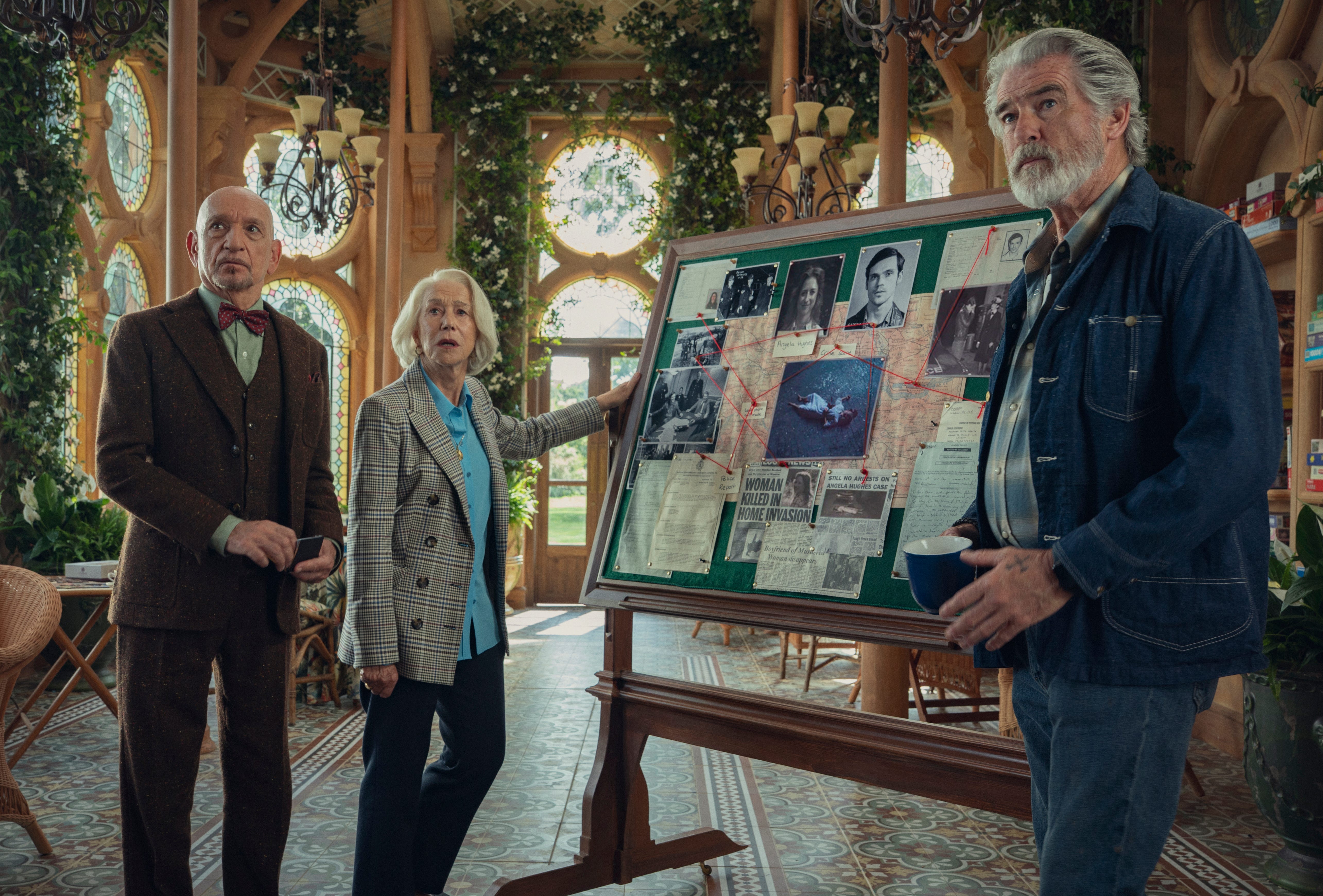 Ben Kingsley, Helen Mirren, Pierce Brosnan next to a board
