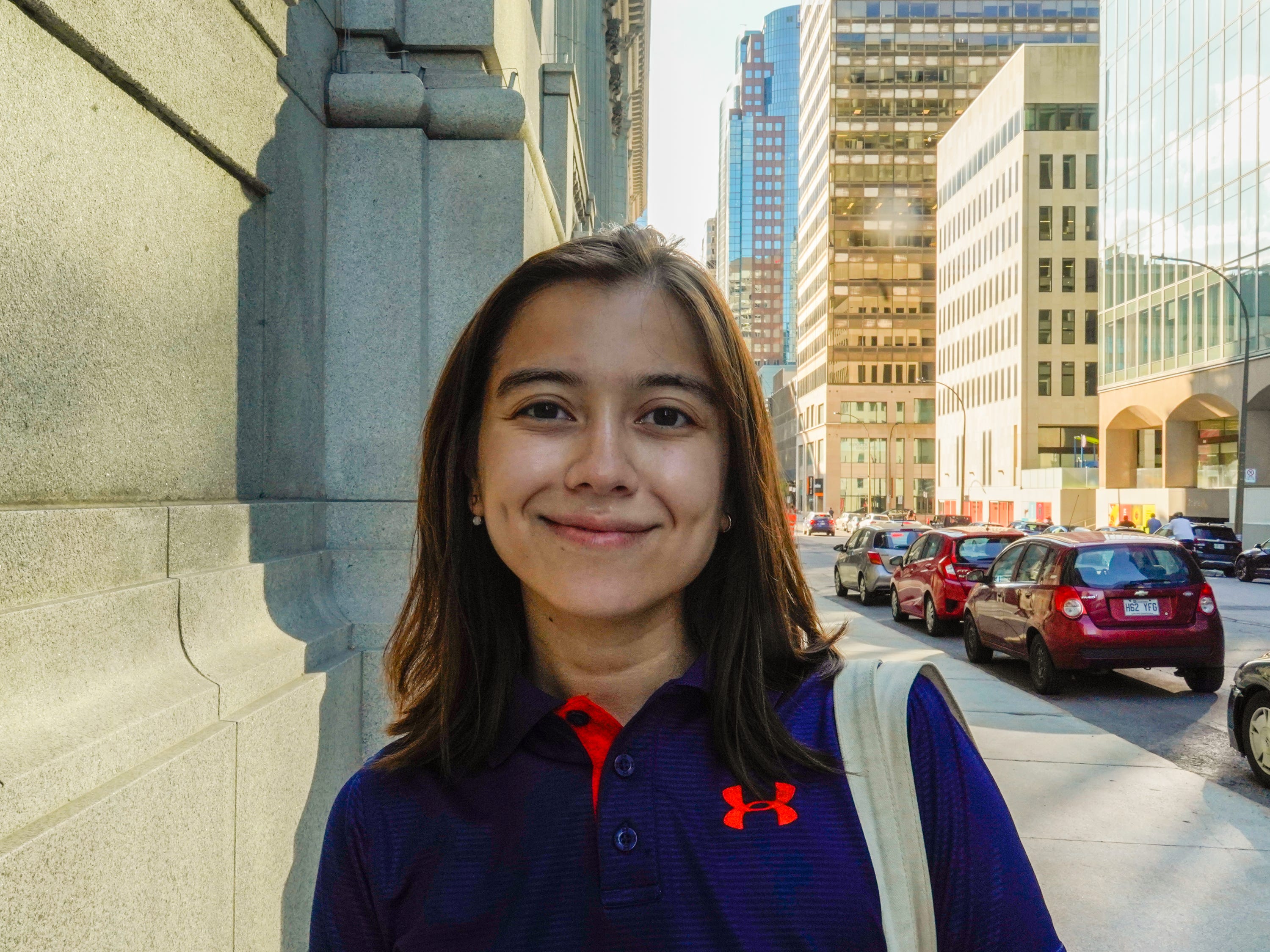 The author stands smiling on a sidewalk in downtown Montreal