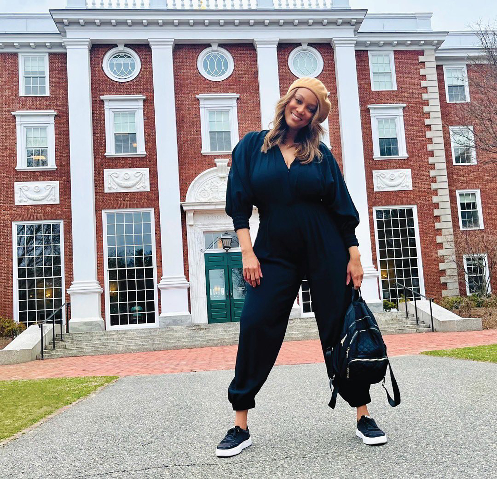 Tyra Banks in a black jumpsuit. 