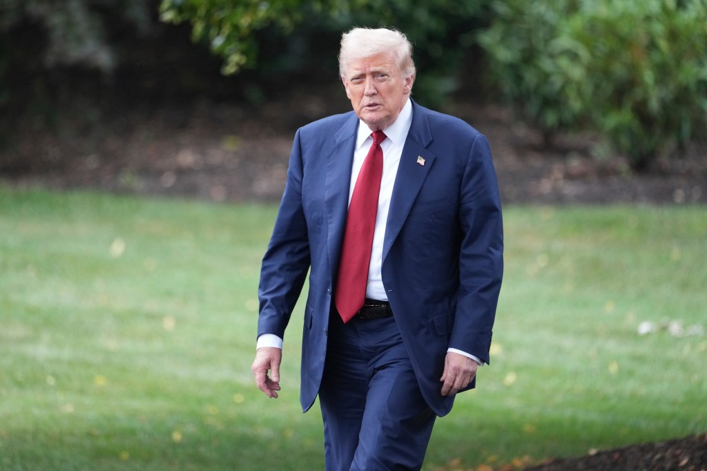 Donald Trump walking on the White House lawn.