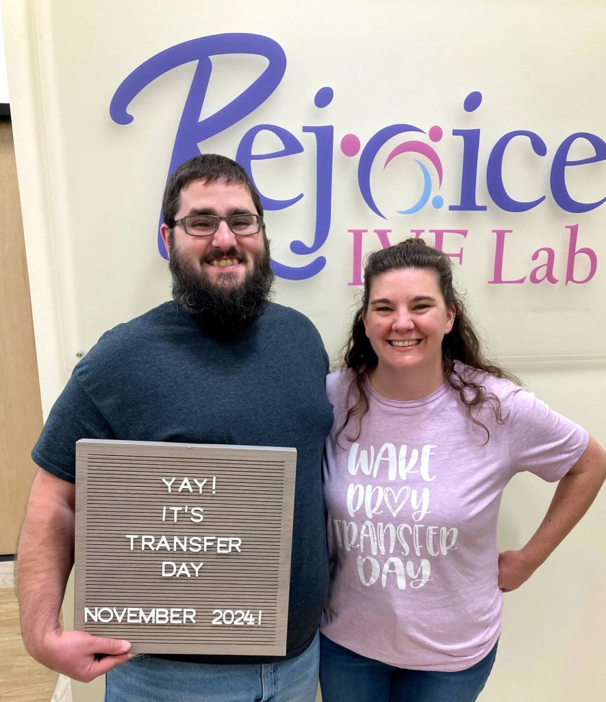 Couple holding a letter board that says 