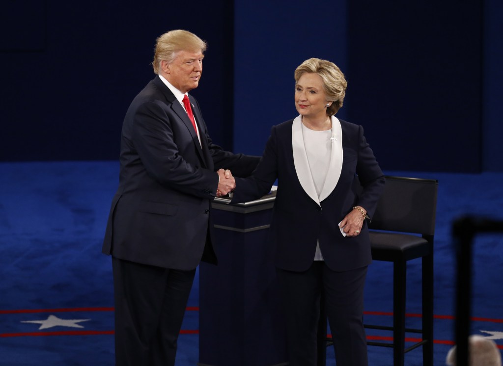 Hillary Clinton and Donald Trump shaking hands at a presidential debate.