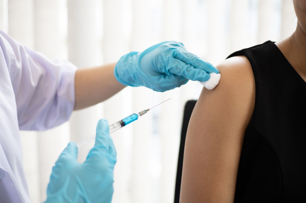 Close-up of a doctor vaccinating a patient.