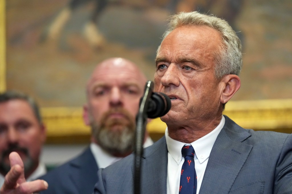 Robert F. Kennedy Jr. speaking at a microphone.